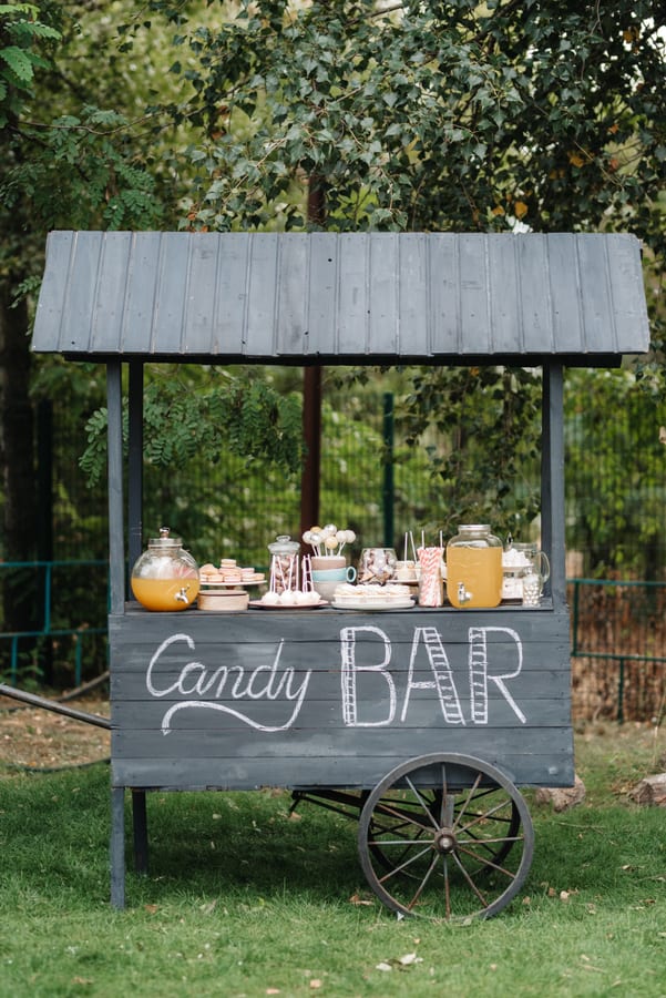 Hire candy cart — candy bar cart with treats in grassy field for parties and events in Johannesburg, Sandton and Randburg
