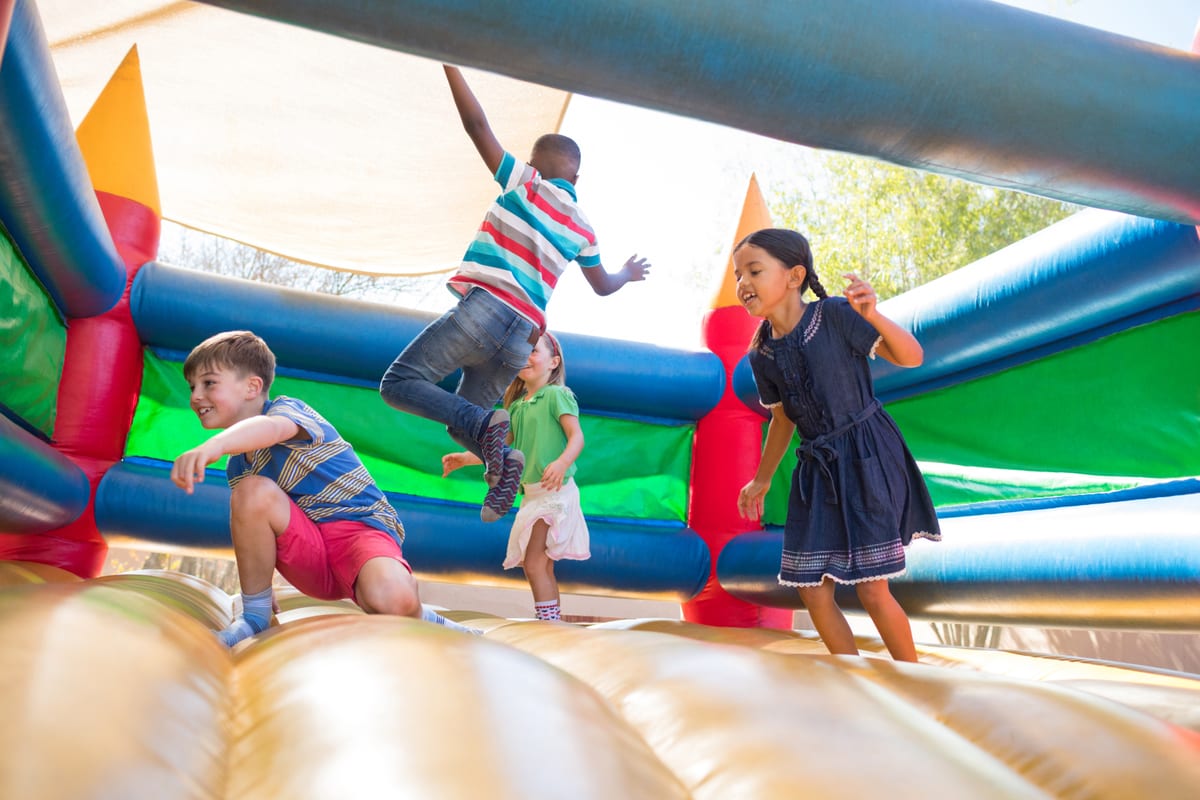 Jumping Castle hire — friends jumping on bouncy castle at playground | Panda Party Hire Hire jumping castle — friends jumping on bouncy castle at playground for parties and events in Johannesburg, Sandton and Randburg