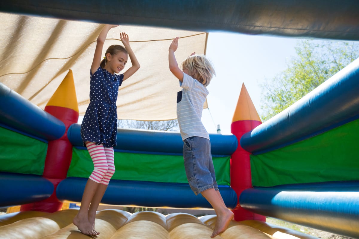 Jumping Castle hire — happy siblings jumping on bouncy castle | Panda Party Hire Hire jumping castle — happy siblings jumping on bouncy castle for parties and events in Johannesburg, Sandton and Randburg