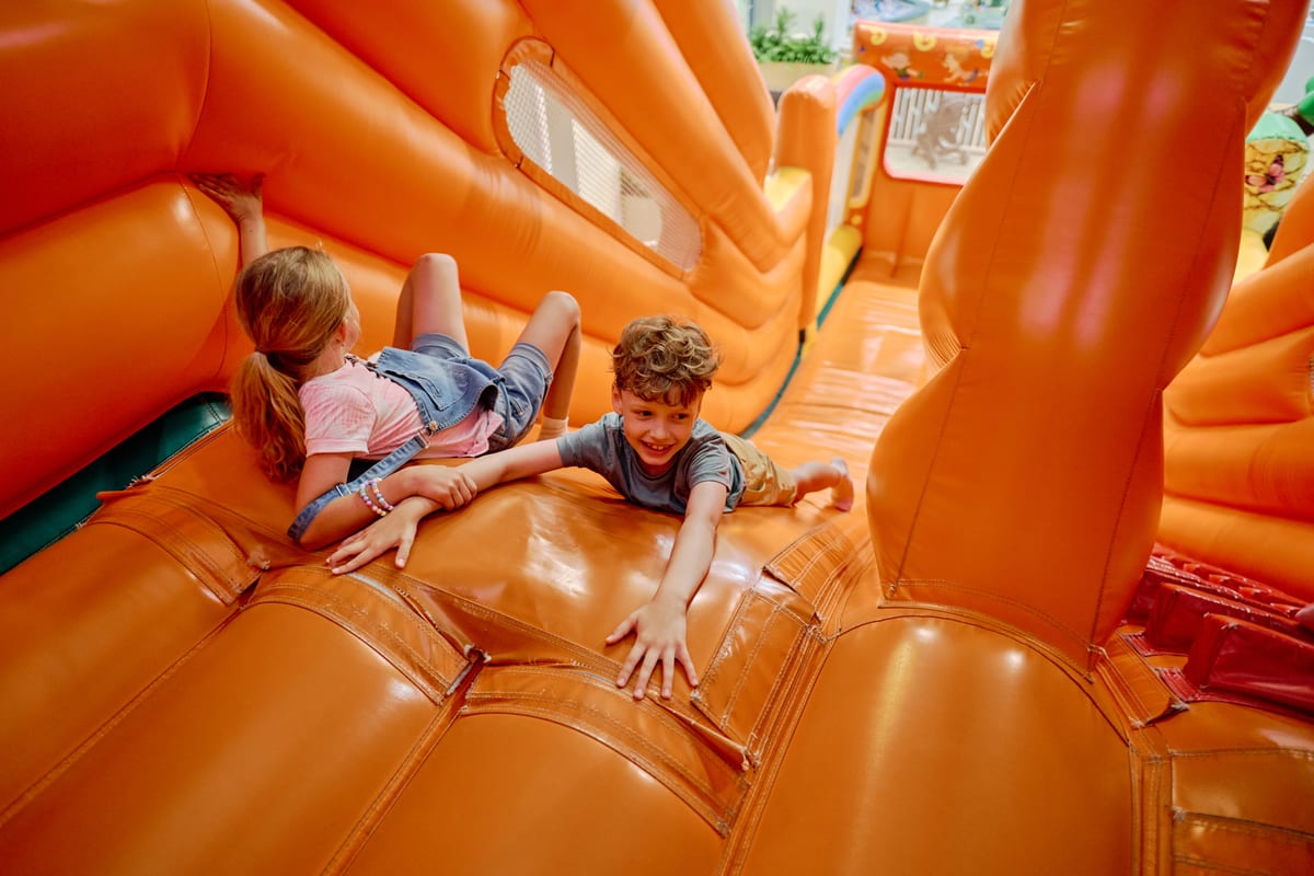 Jumping Castle hire — children playing on an orange inflatable structure | Panda Party Hire Hire jumping castle — children playing on an orange inflatable structure for parties and events in Johannesburg, Sandton and Randburg