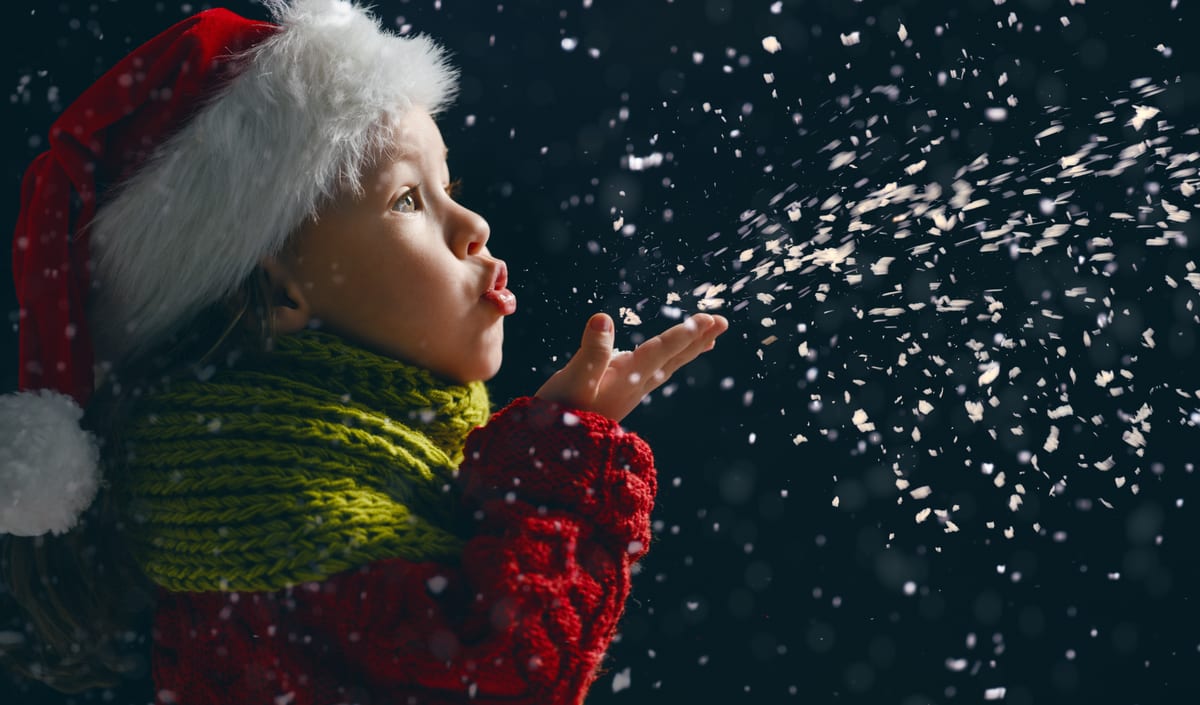 Snow Machine hire — girl blowing glitter wearing a santa hat | Panda Party Hire Hire snow machine — girl blowing glitter wearing a santa hat for parties and events in Johannesburg, Sandton and Randburg