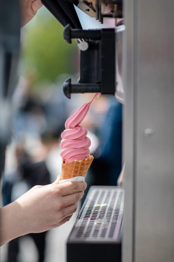 Soft Serve Machine hire — vertical view of a person s hand holding an ice cr | Panda Party Hire Hire soft serve machine — vertical view of a person s hand holding an ice cr for parties and events in Johannesburg, Sandton and Randburg