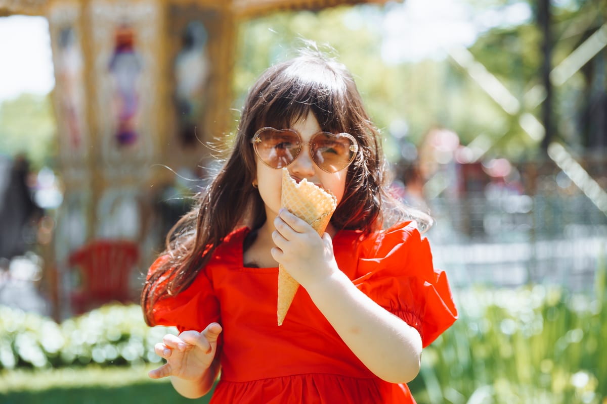 Soft Serve Machine hire — a little girl in a red dress and a straw hat eats | Panda Party Hire Hire soft serve machine — a little girl in a red dress and a straw hat eats for parties and events in Johannesburg, Sandton and Randburg