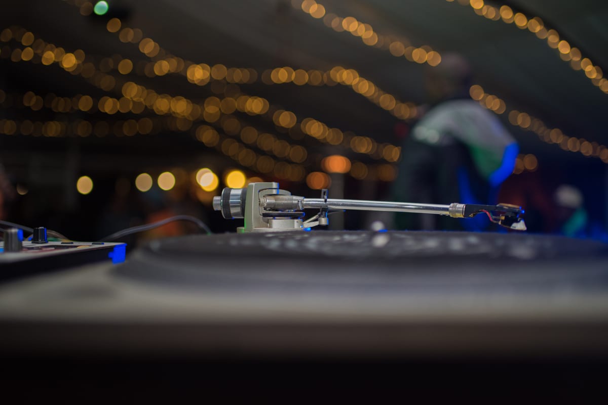 Sound System hire — close up shot on turntable with performer blurred | Panda Party Hire Hire sound system — close up shot on turntable with performer blurred for parties and events in Johannesburg, Sandton and Randburg